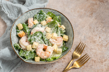 Fresh caesar salad on bowl with parmesan cheese and shrimps