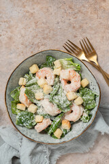 Fresh caesar salad on bowl with parmesan cheese and shrimps
