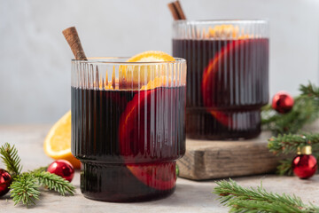 Spiced citrus mulled wine on white linen surface