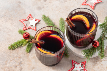 Spiced citrus mulled wine on white linen surface
