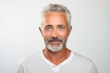 Portrait of handsome senior man in white t-shirt on grey background - obrazy, fototapety, plakaty