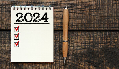 New year resolutions 2024 on desk. 2024 goals list with notebook. Resolutions, plan, goals, action,...