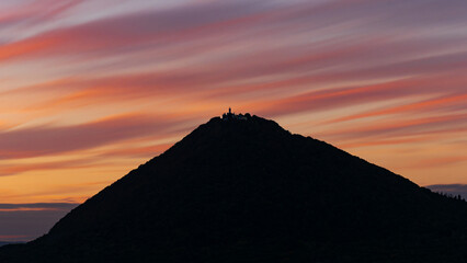 silhouette of the highest mountain in the Czech Central Mountains Milešovka at sunset