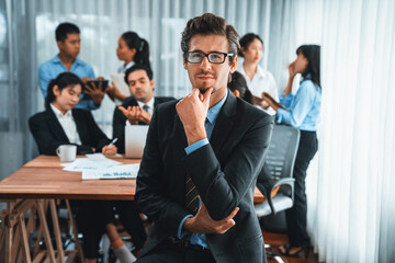 Portrait of happy businessman looking at camera with motion blur background of business people movement in dynamic business meeting. Habiliment - obrazy, fototapety, plakaty