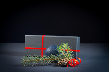 Christmas tree, decorations and a gift box on a black background