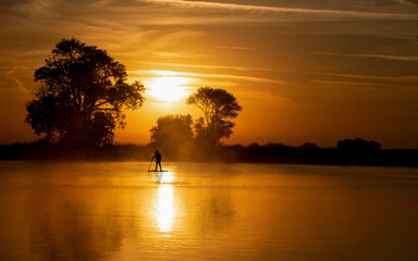 Great time for a workout paddle boarding on the delta river in Isleton Ca. in the early morning in fall autumn 