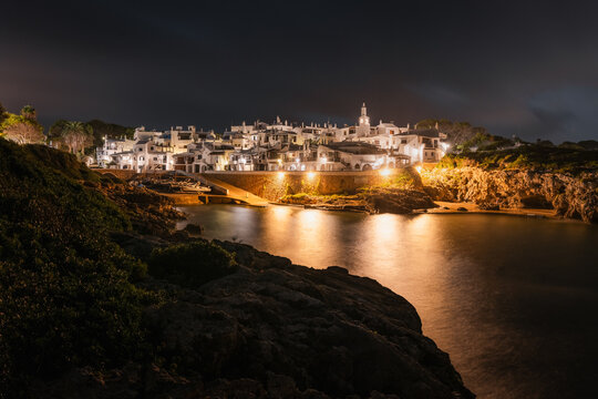 Panoramic view, at night, of Binibeca, a typical white mediterranean village, located on the southern coast of Menorca/Minorca island, in the Balearic Islands, Spain.