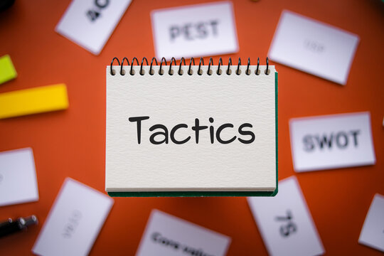 There is notebook with the word Tactics. It is as an eye-catching image.
