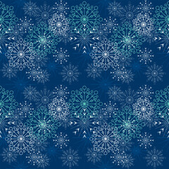 Seamless Christmas pattern of many snowflakes and blue background.