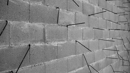 gray wall made of concrete blocks and metal reinforcement
