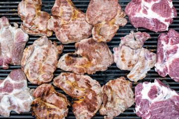 Pork (pork neck) grilled on charcoal. Shot from above. It's time to grill! Barbecue.  Meat steak grilled on a stainless steel grill.