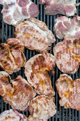 Pork (pork neck) grilled on charcoal. Shot from above. It's time to grill! Barbecue.  Meat steak grilled on a stainless steel grill.