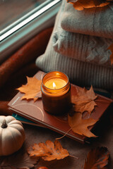 Lit Candle Casting a Warm Glow, Surrounded by the Rich Tapestry of Fall's Fading Leaves, Bountiful...