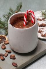 Cozy winter lifestyle concept. Mug of hot drink with vintage book and tasty homemade Christmas gingerbread cookies.
