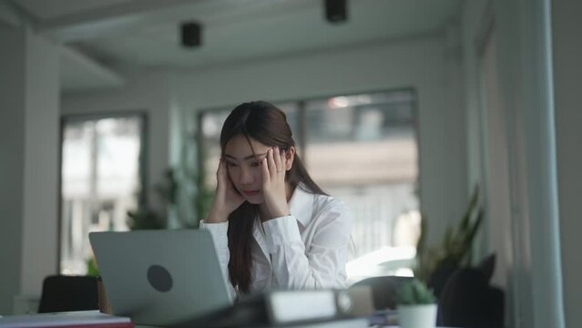 Asian woman bored with office routine
