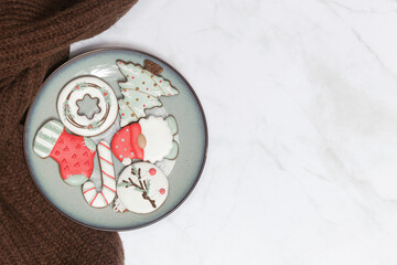 Plate with tasty homemade Christmas gingerbread cookies, top view, flat lay with space for your xmas greetings, concept of winter holidays desserts and decoration