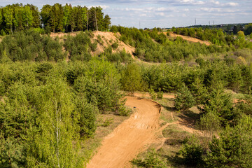 Fototapeta na wymiar View of the motorcycle racing track on the territory of the old sand quarry
