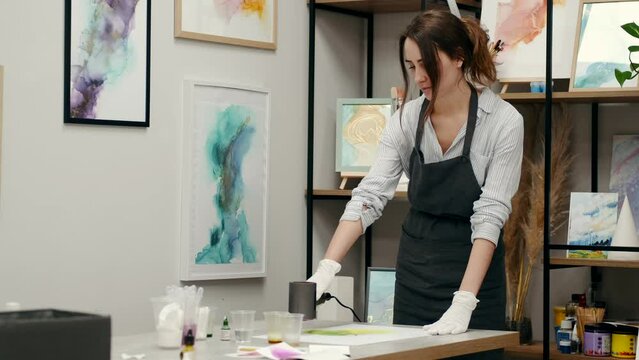 girl painting expressing herself and showing her hobby in a colored painting 