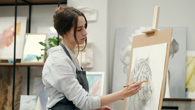 girl painting expressing herself and showing her hobby in a colored painting 
