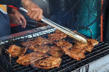 Grilled pork neck on the grill. Eat with With spicy sauce, soft and chewy, very delicious taste. Restaurant menu. Thai food style