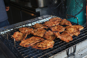 Grilled pork neck on the grill. Eat with With spicy sauce, soft and chewy, very delicious taste. Restaurant menu. Thai food style