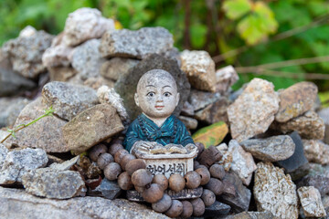Small Statue Readnig in a Stone Forest