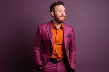 Portrait of a stylish young man in a purple suit. Studio shot.