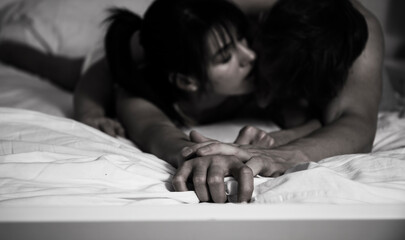 Shot of a happy young couple relaxing in bed together at home.