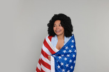 4th of July - Independence Day of USA. Happy woman with American flag on light grey background