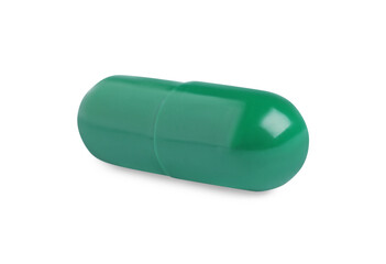 One green pill on white background. Medicinal treatment
