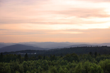 Picturesque view of mountains covered with forest under sky