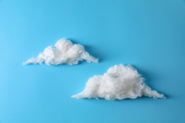 Clouds made of cotton on light blue background