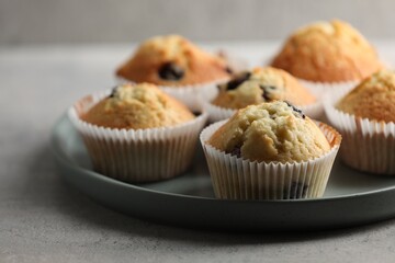 Delicious sweet muffins with berries on grey table, closeup