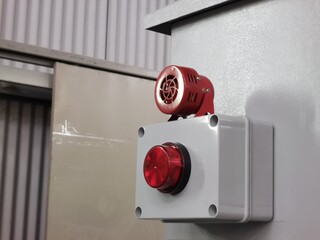 Alarm siren with strobe light mount on electrical cabinet.