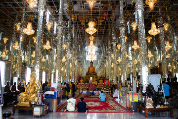 Buddha statue in antique glass ubosot hall for thai people travelers travel visit respect praying...