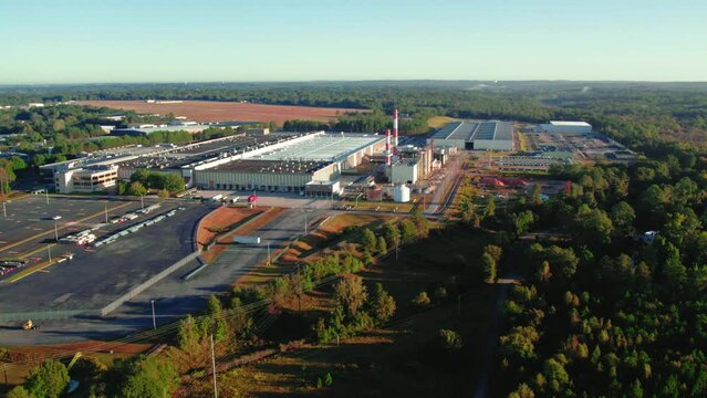 aerial of a tissue products manufacturer in Macon Georgia. Semi truck driver slow driving.