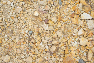 Texture of yellow crushed stone at construction site in summer. High quality photo