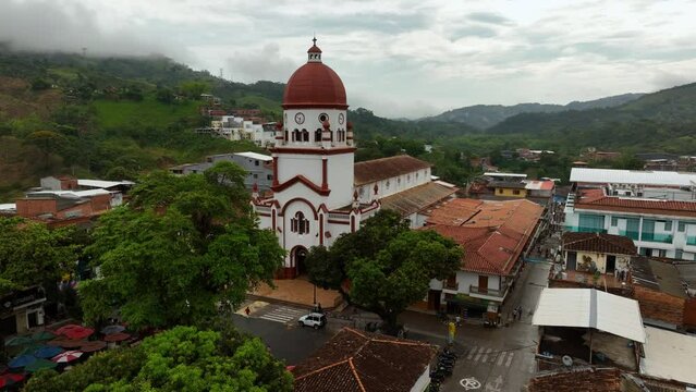 Aerial view rising in front of the St Raphael's Church in cloudy Antioquia, Colombia