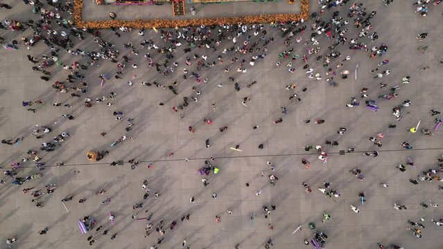 Drone birds eye view of people walking in the zocalo of Mexico City on Day of the Dead