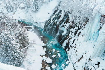 Shirahige Waterfall with Snow in winter, Biei river flow into Blue Pond. landmark and popular for...