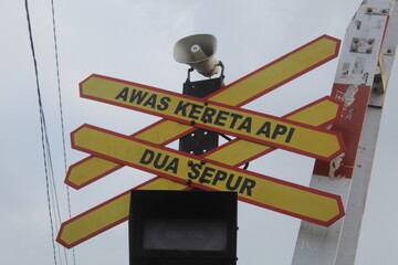 Railway traffic signs in Indonesia against a backdrop of blue sky on a clear morning