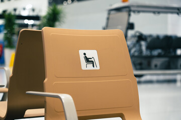 Disable chair seats in a new airport with nobody - obrazy, fototapety, plakaty