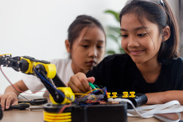 nventive kids learn at home by coding robot cars and electronic board cables in STEM. constructing...