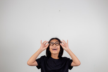 cute little preschooler girl isolated on grey studio background wear glasses look at camera, small child try spectacles at opticians, kid eyesight correction treatment concept