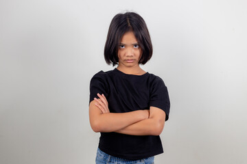 Angry little girl over white background, sign and gesture concept - obrazy, fototapety, plakaty