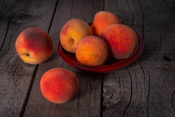 Fototapeta na wymiar Ripe Fresh Peaches Fruits on Wooden Surface.