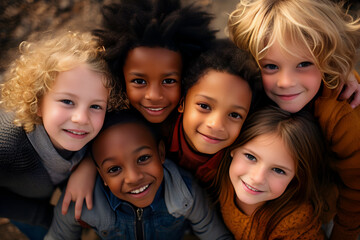 Obraz premium Faces of happy multinational children hugging and smiling for the camera