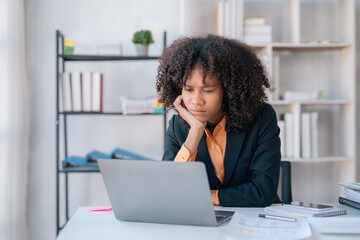 Young African American business woman worried about problem at work and stressed about problem with laptop computer.