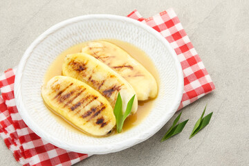 Pisang Gapit or Pisang Epe, grilled banana with palm sugar sauce. Indonesian traditional food.
