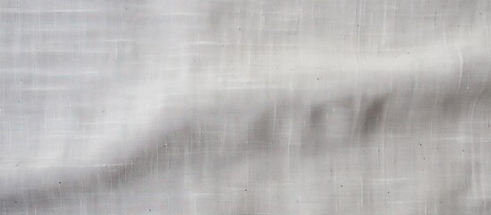 A canvas background with a natural linen texture in light gray suitable for designing purposes seen from a top view